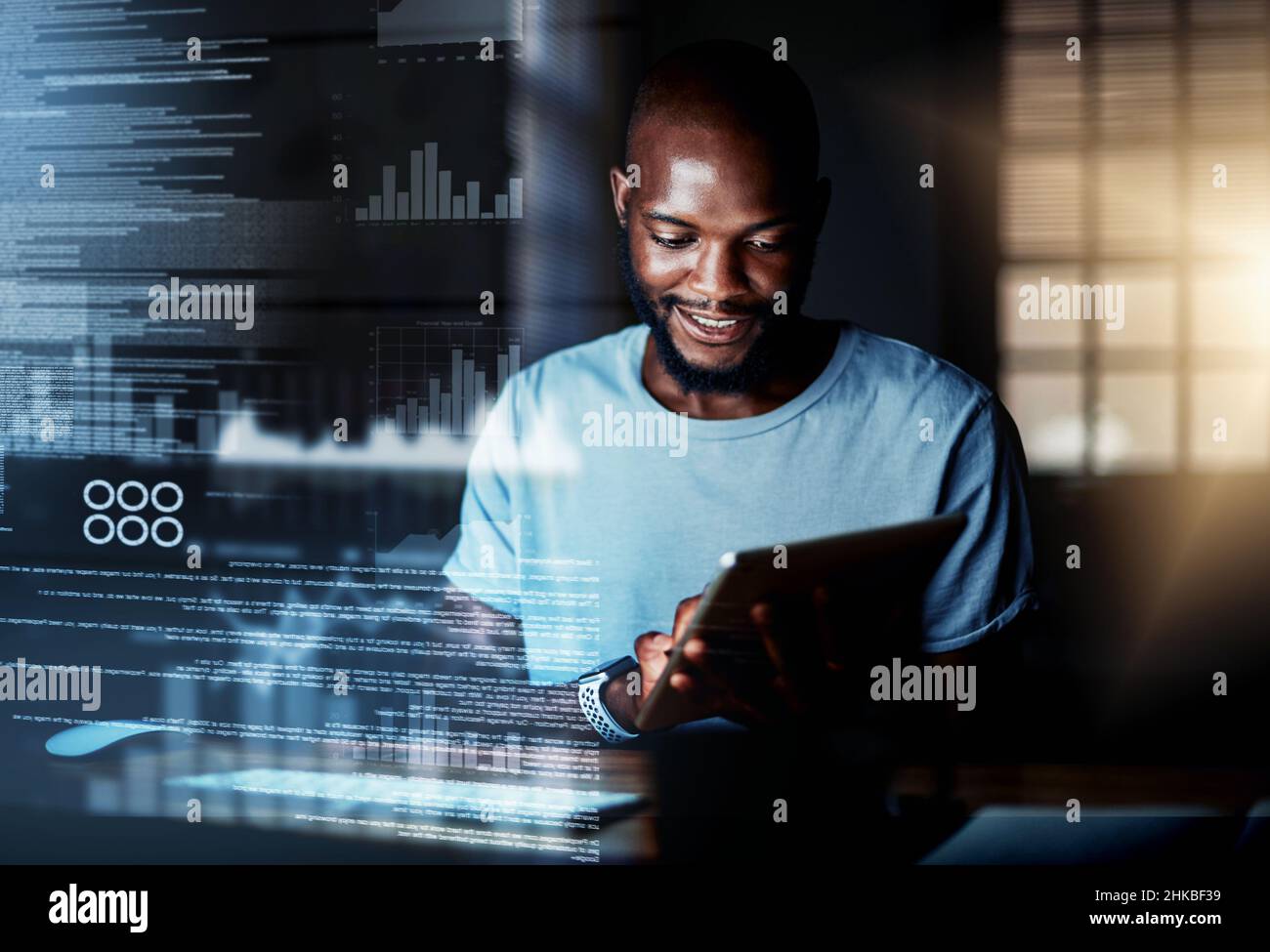 Deciphering new data. Shot of a programmer using a digital tablet while working on a computer code at night. Stock Photo