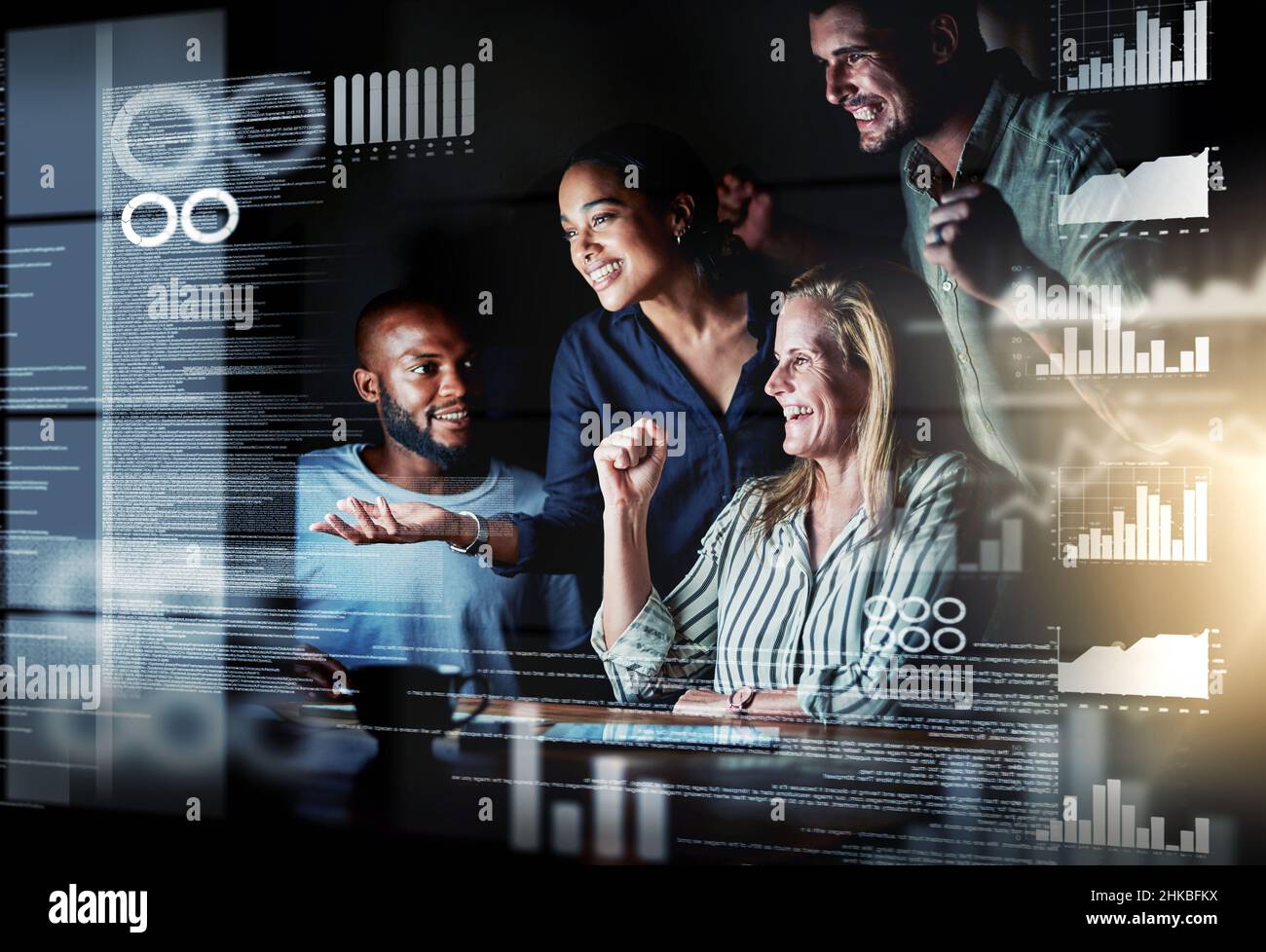 We totally cracked it. Shot of a group of programmers working together on a computer code at night. Stock Photo