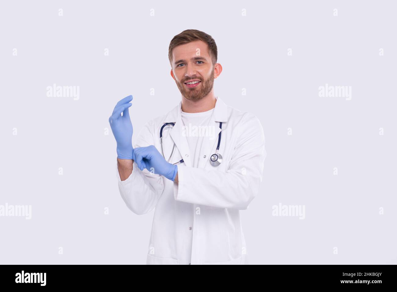 Doctor Puts on Gloves Isolated. Man Doctor Protection Workwear. Medical Concept Corona Virus. Gloves Stock Photo