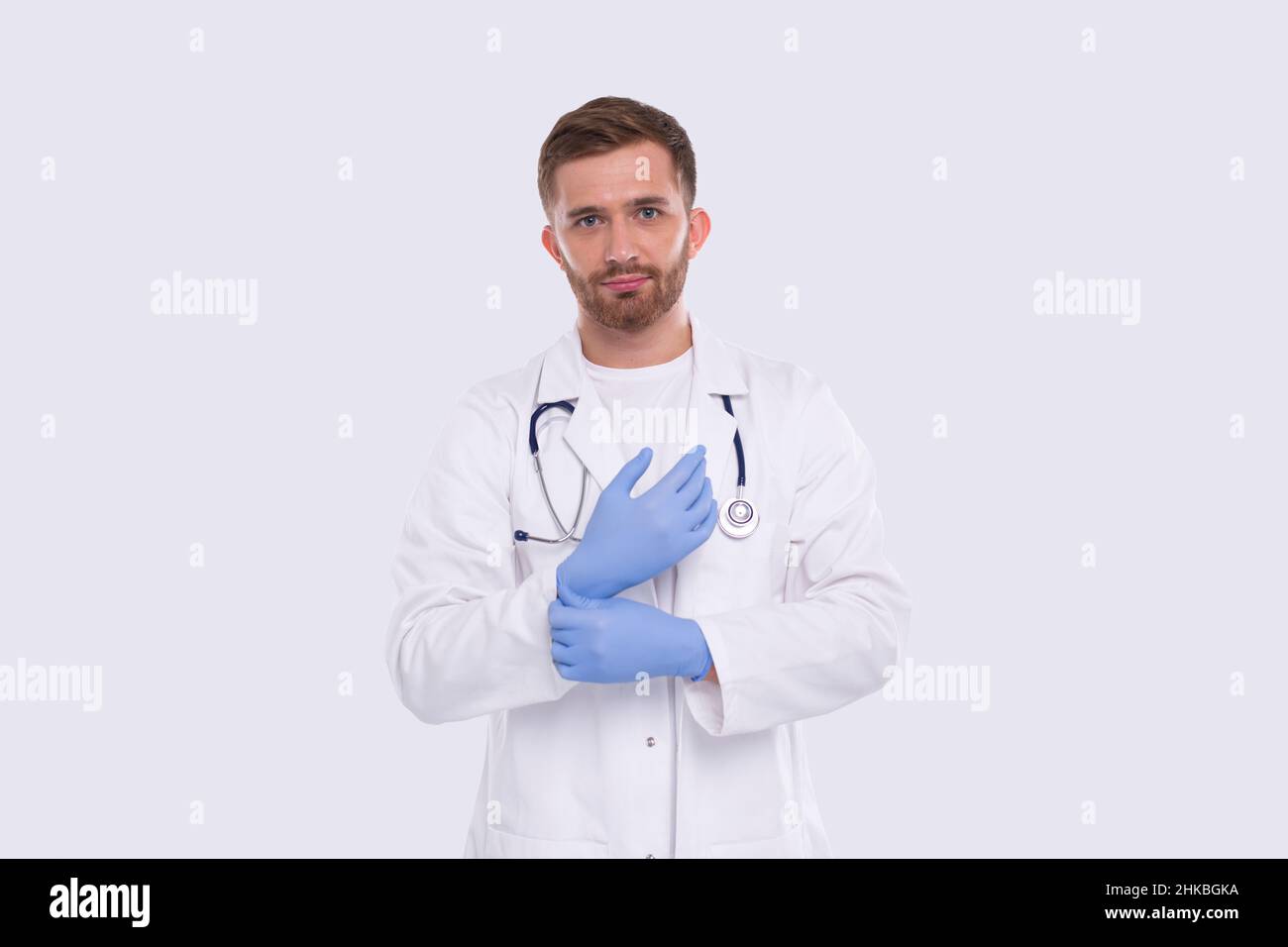 Doctor Puts on Gloves Isolated. Man Doctor Protection Workwear. Medical Concept Corona Virus. Gloves Stock Photo