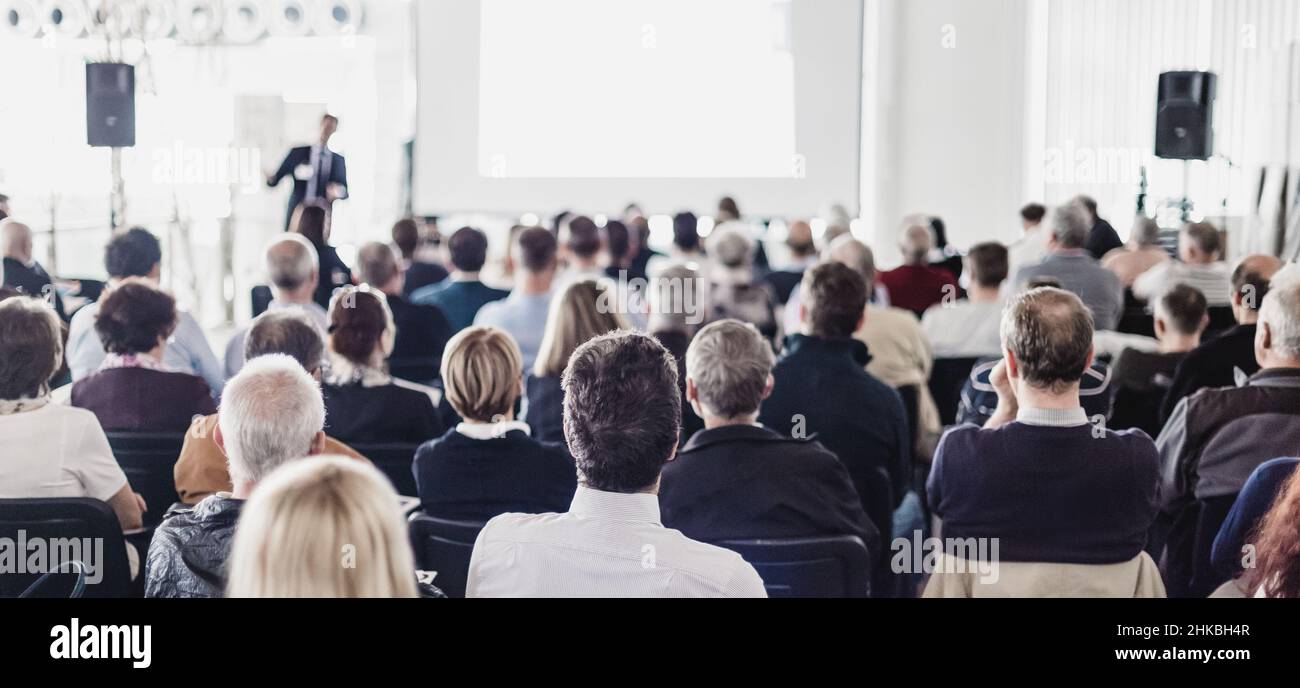 Speaker at Business Conference with Public Presentations. Audience at the conference hall. Business and Entrepreneurship concept. Stock Photo