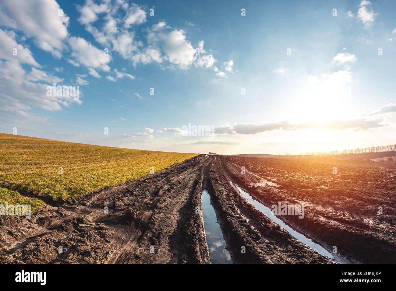 Very bad road in an agricultural field. Farm land in spring. Inspection of winter crops Stock Photo