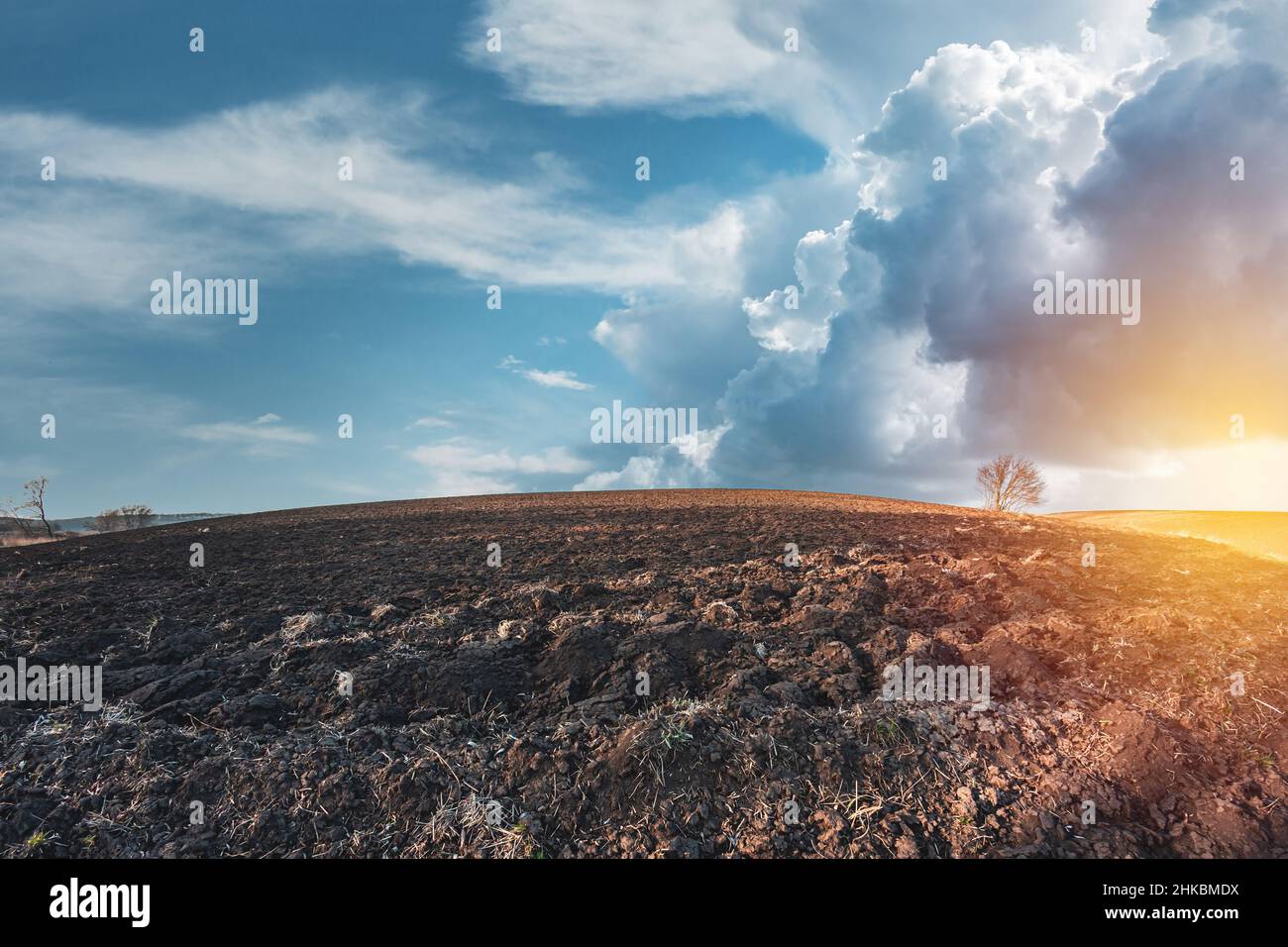 Agricultural field without plants in spring. Rainy sky over farm land Stock Photo