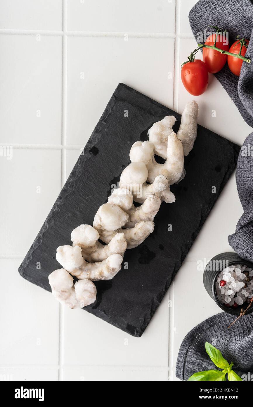 Thawed peeled shrimp, seafood, delicacy. on a white background, in a ...
