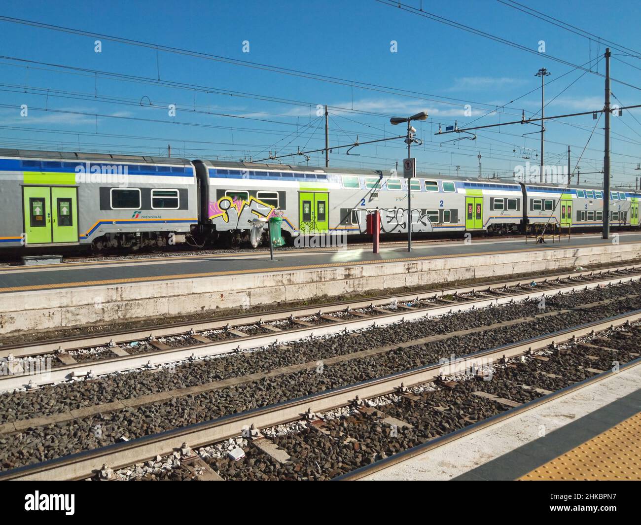 Train covered with some graffiti, leaving Roma Termini railway station. Stock Photo
