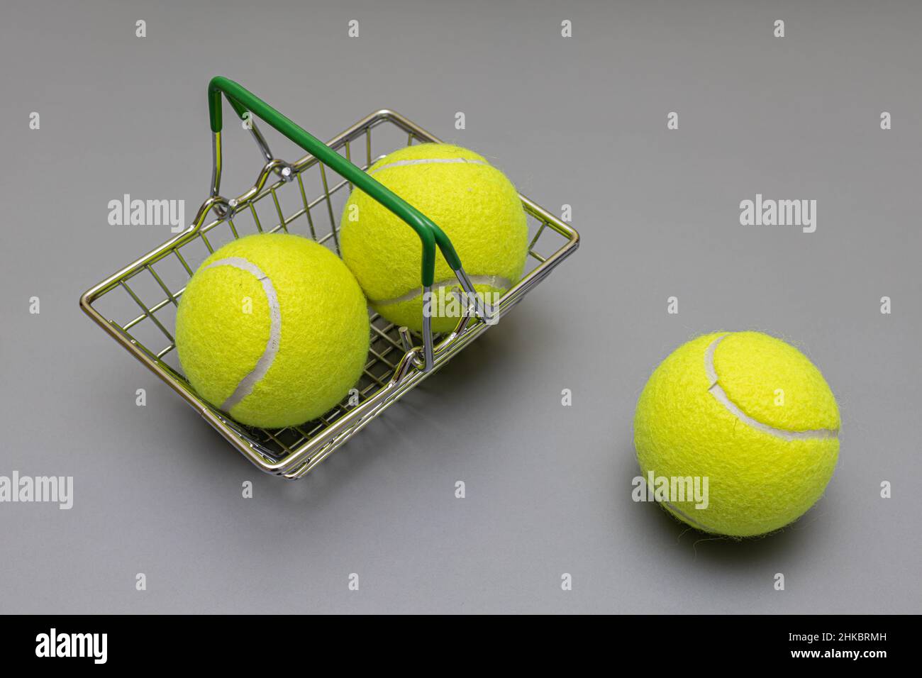 tennis balls in a miniature grocery basket Stock Photo Alamy