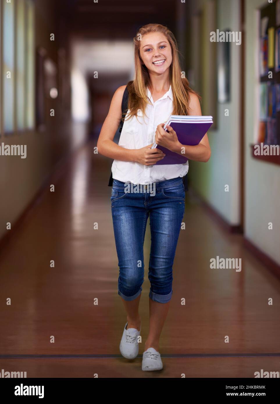She's a diligent student. Shot of a young girl in her school hallway. Stock Photo