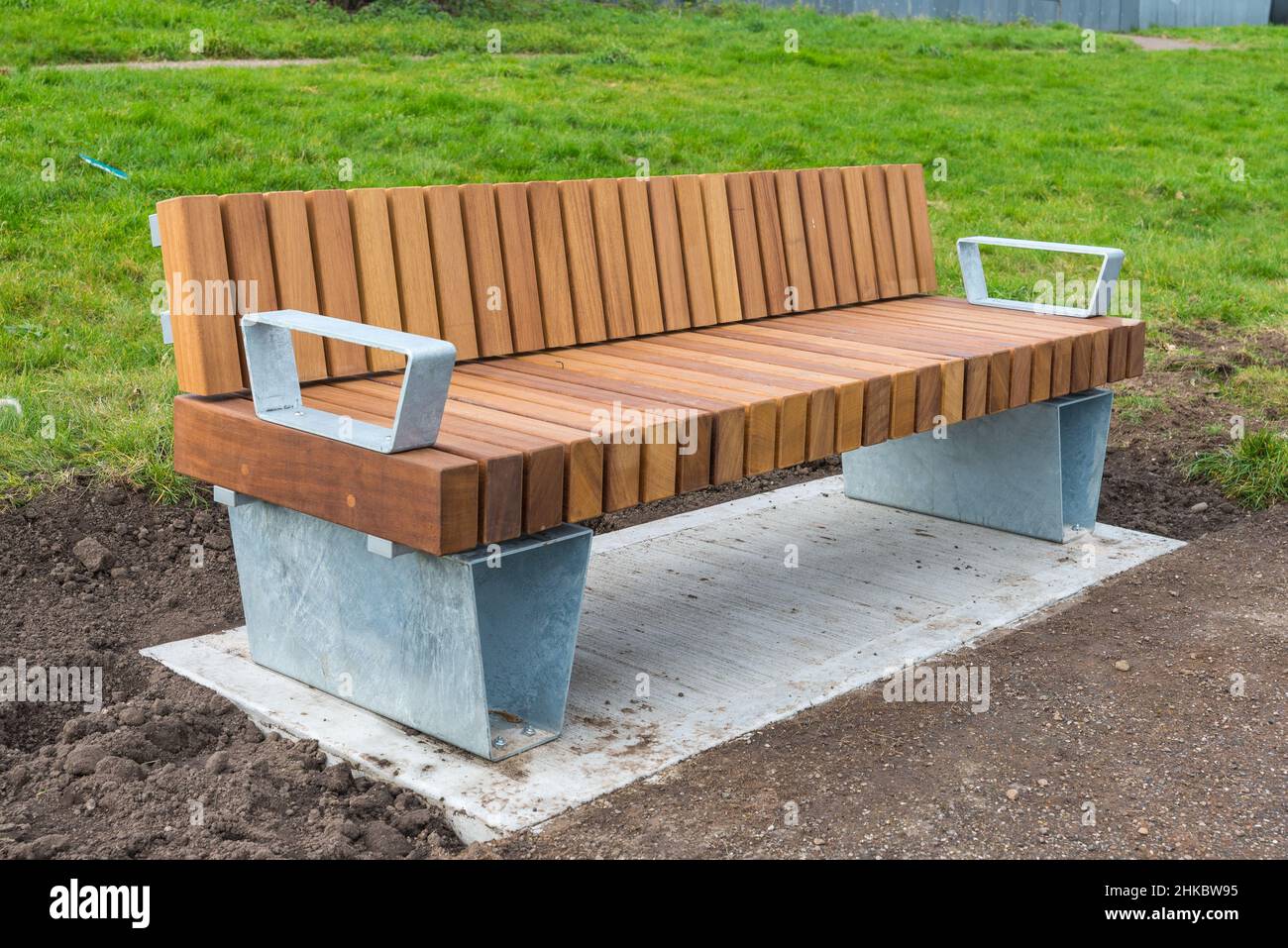 New modern wooden and aluminium park bench installed around Alexander Stadium in Perry Barr, Birmingham ready for the Commonwealth Games 2022 Stock Photo