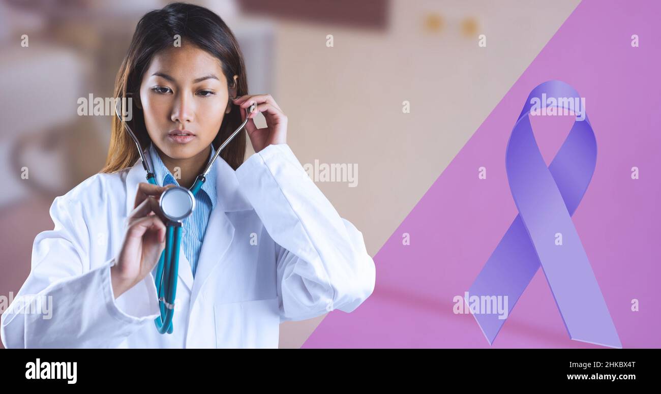 Cancer awareness ribbon and asian female young doctor examining with stethoscope Stock Photo