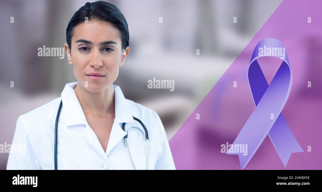 Digital composite image of blue awareness ribbon and confident biracial mid adult female doctor Stock Photo