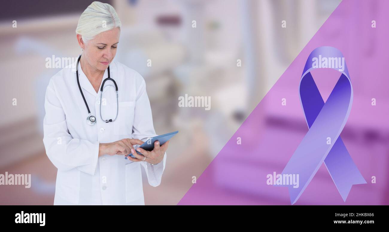 Blue cancer awareness ribbon and caucasian mature female doctor using digital tablet Stock Photo