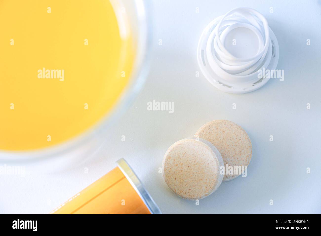 Vitamin C dissolvable tablets out of a tube on a white table, vitamin C