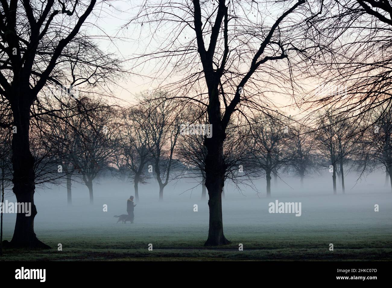 Pedestrians walk in a mistcovered park in Ilford, East London, in the