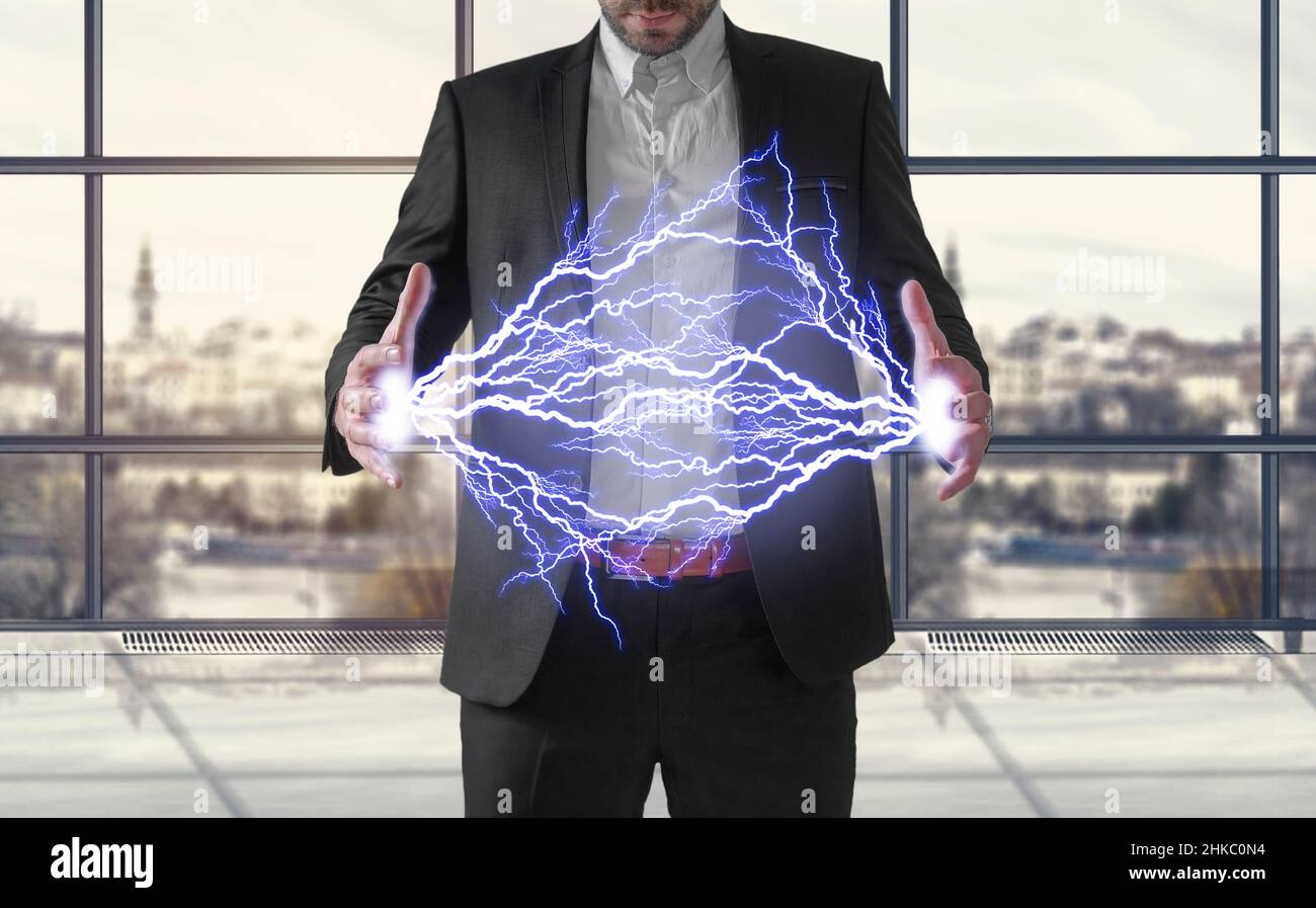 Business man making electricity light bolt from his hands concept Stock