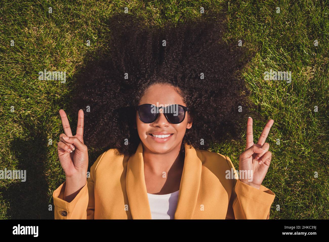 Top above high angle view portrait of attractive cheerful girl lying on