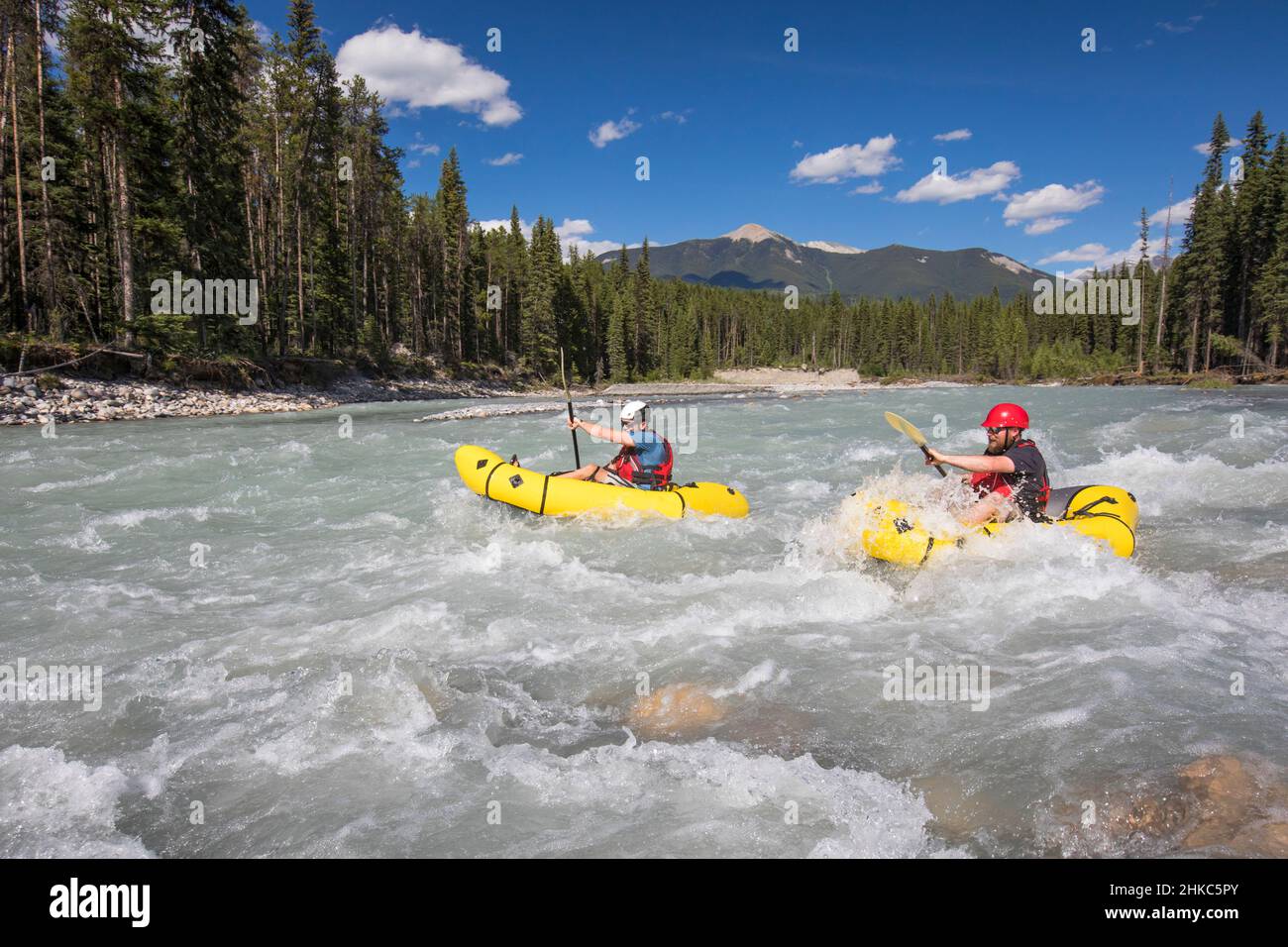 Two men packrafting through white water, Kootney National Park. Stock Photo