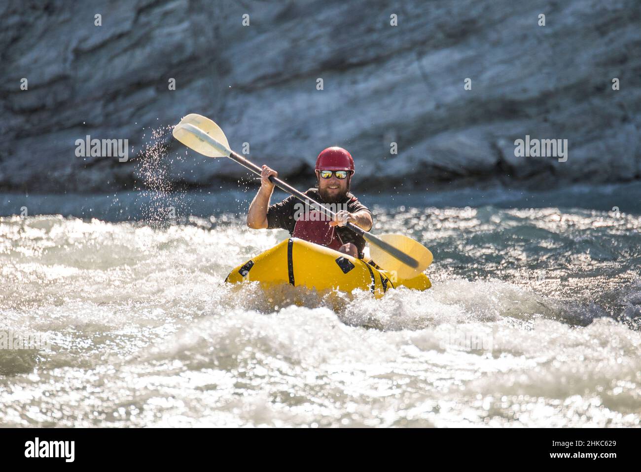 Man paddles through white water on the Kootney River, B.C. Stock Photo