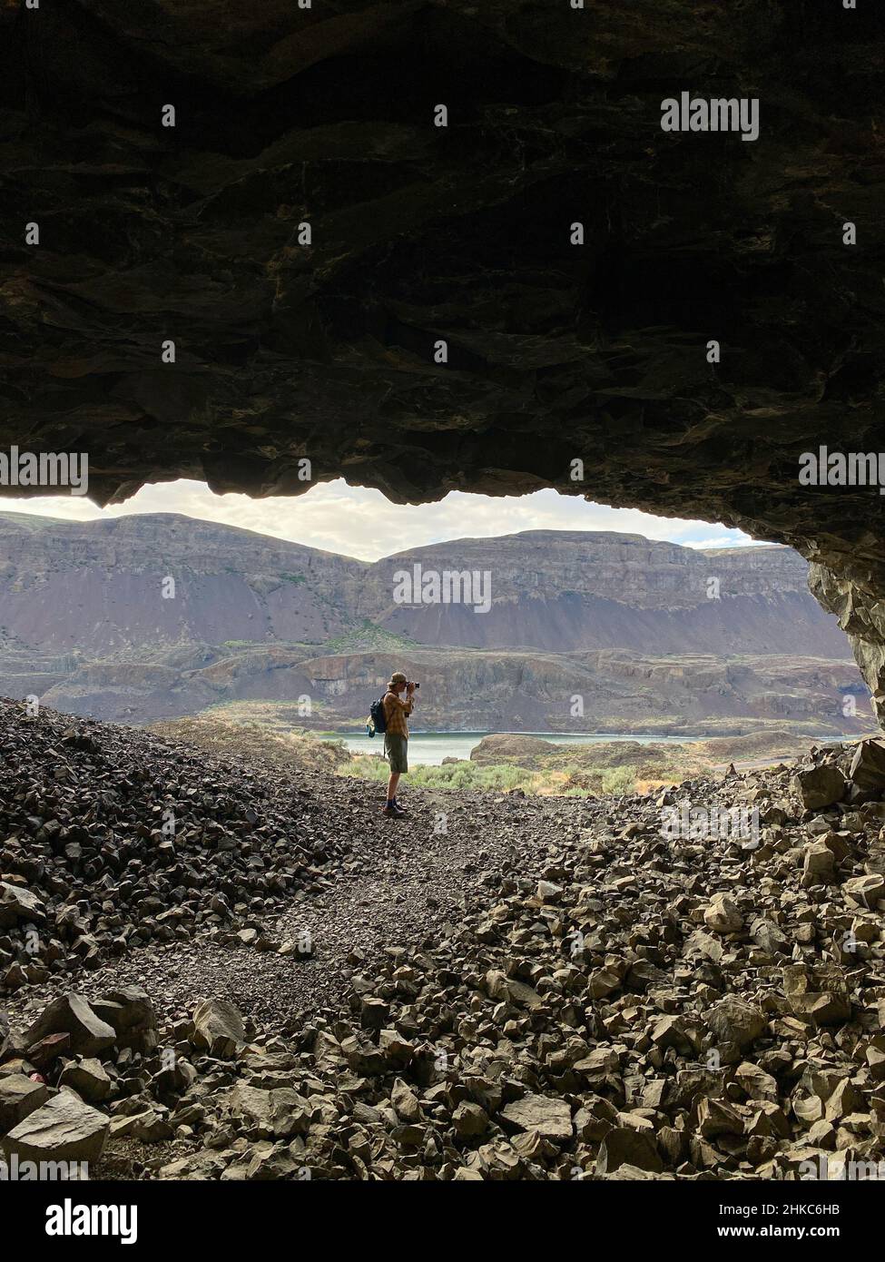 Male photographer taking photo in Lenore Caves in eastern Washington Stock Photo