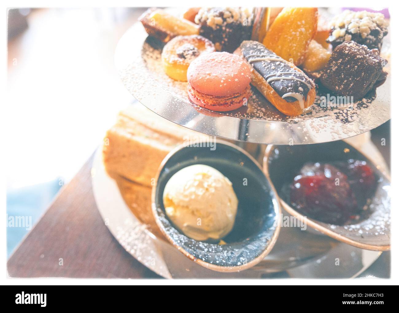 Delicious cake stand full of fancy cakes and sandwiches for English afternoon tea Stock Photo