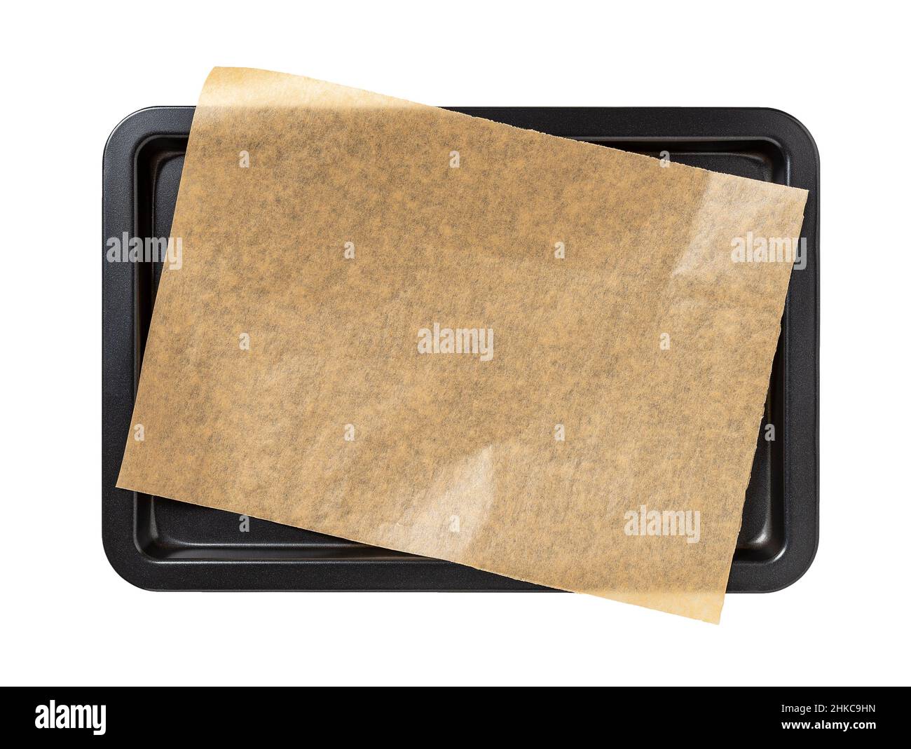Baking sheet with brown parchment paper isolated on white background