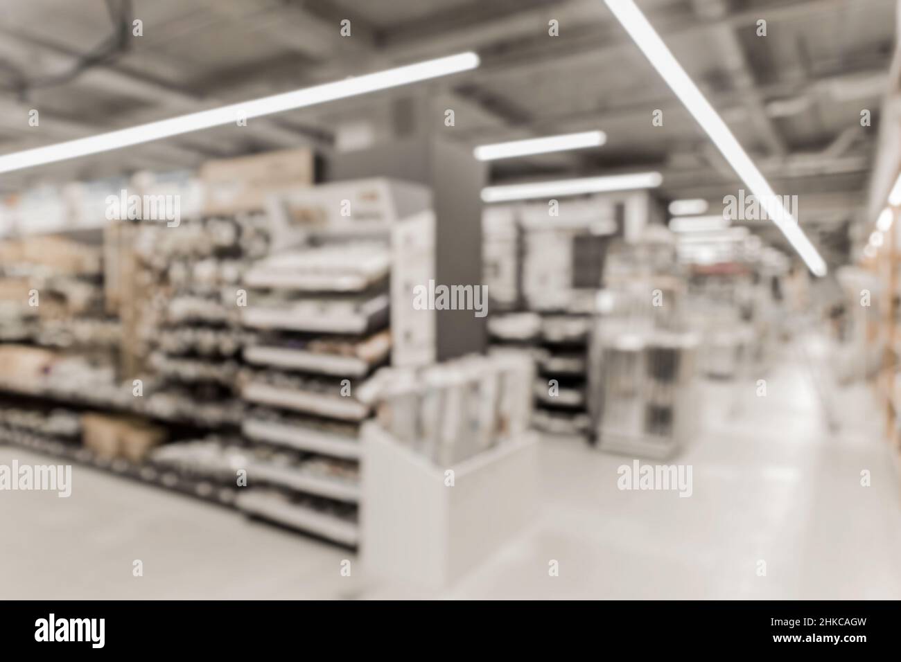 Blurry background of a hardware store with shelves and materials for interior and home design. Stock Photo