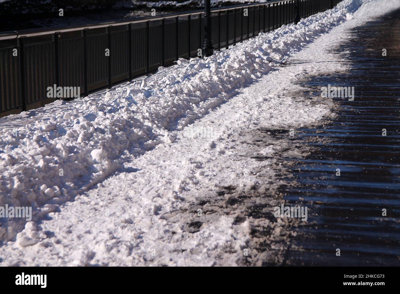 The fresh snow on the wooden walkaway in a sunny winter and cold day Stock Photo