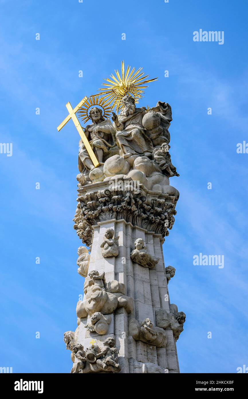 Fragment of Holy Trinity Column (plague column) in Budapest against blue sky with clouds. Plague Column located on Castle hill in middle of Trinity Sq Stock Photo