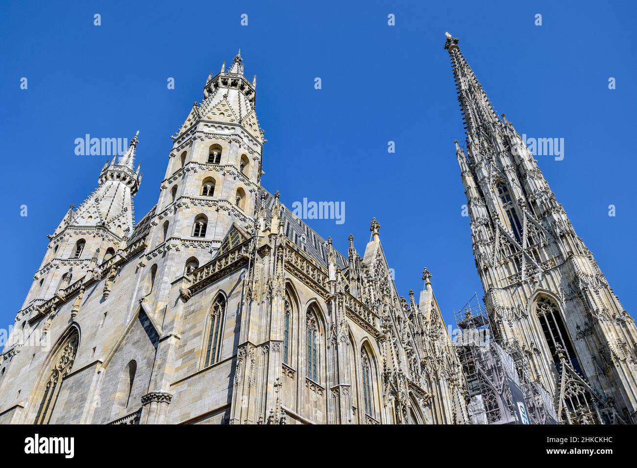 Vienna, Austria, may 2019: Details of the roof and tower of the Stephansdom -St Stephen's church view against blue sky, one of the main tourist destin Stock Photo