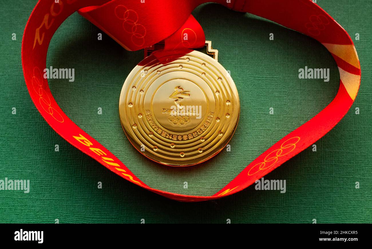 January 27, 2022, Beijing, China. XXIV Olympic Winter Games gold medal on a green background. Stock Photo