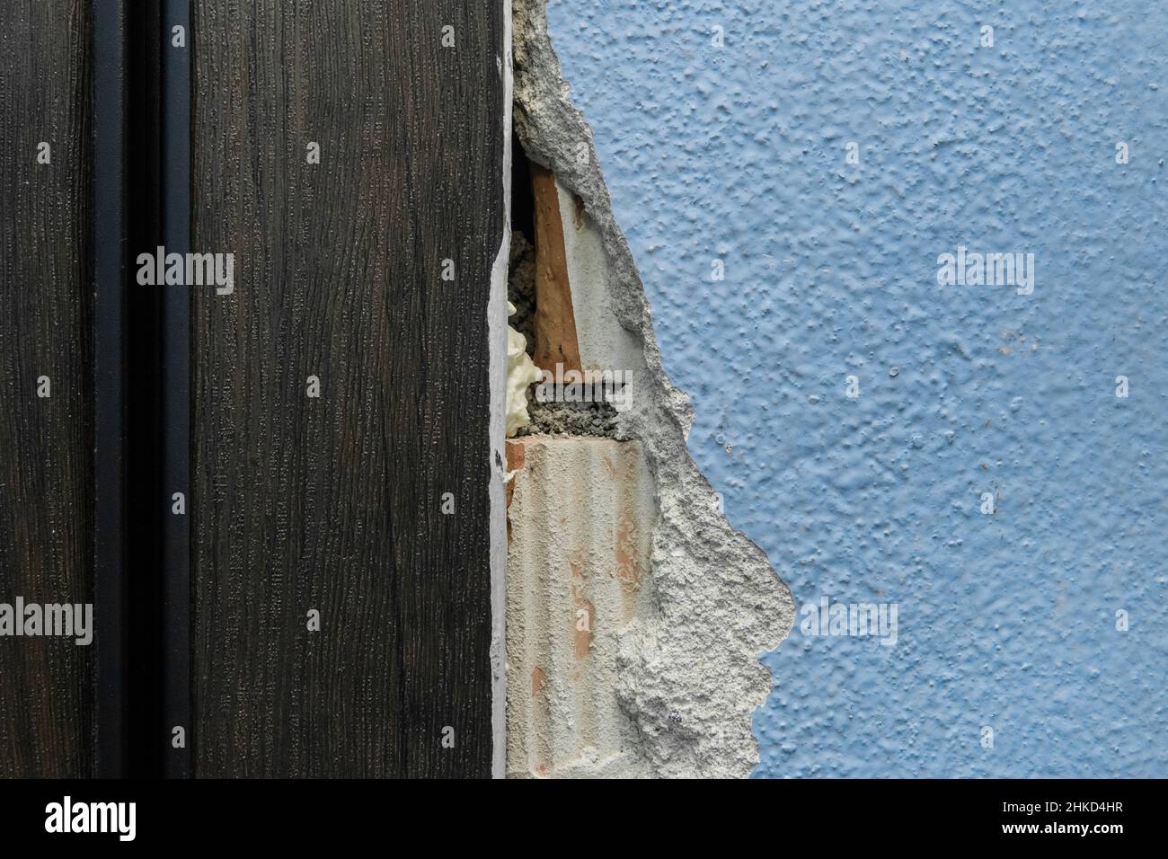 Old broken damaged concrete wall in need of repair and reconstruction of the apartment architecture of the house. Stock Photo