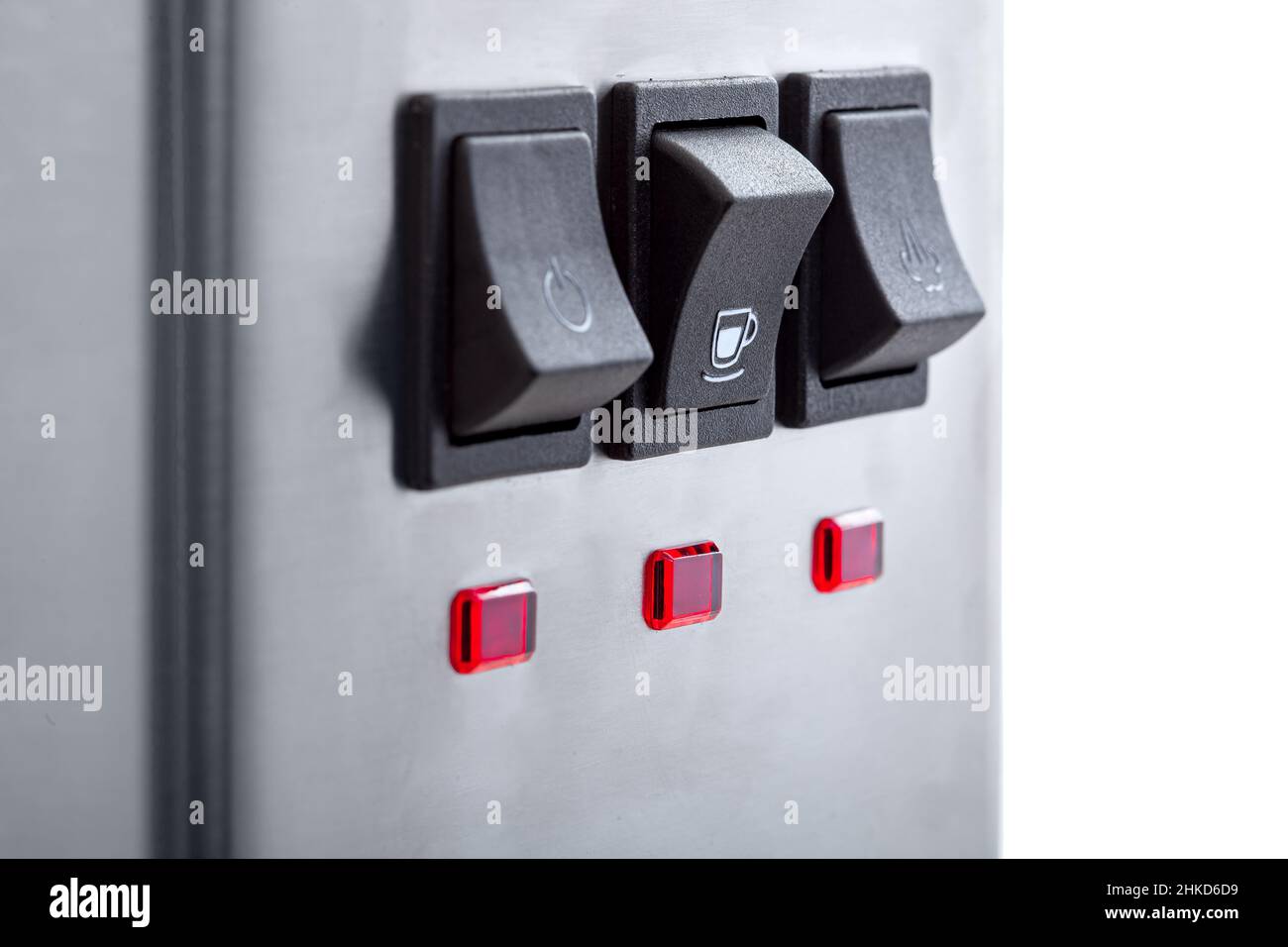 Black button for making coffee with a white cup icon, closeup of the