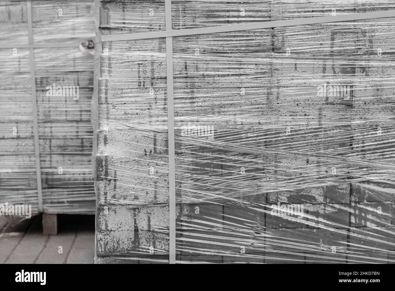 Stone pavement blocks in a pile of tiles building material packed in polyethylene film on