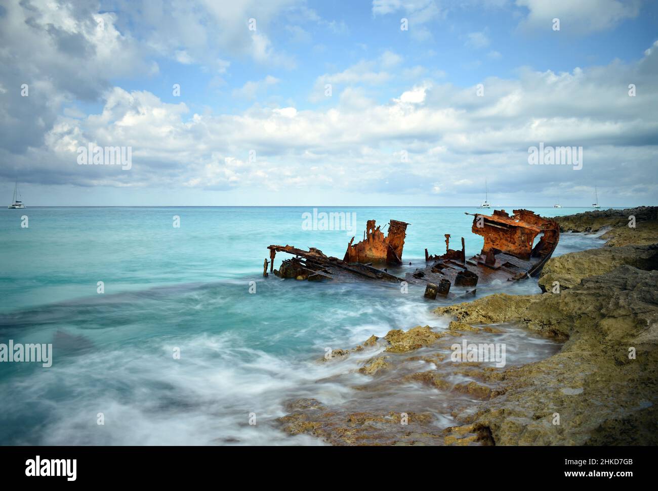 A long exposure shot of waves hitting the rocks and the rusty hull of the Gallant Lady shipwreck, North Bimini, Bahamas Stock Photo