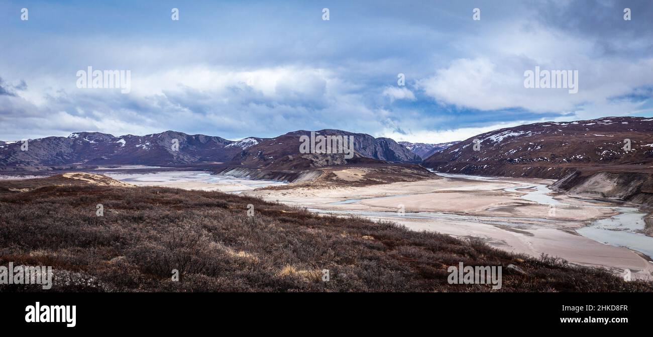 Greenlandic wastelands landscape with river and mountains in the background, Kangerlussuaq, Greenland Stock Photo