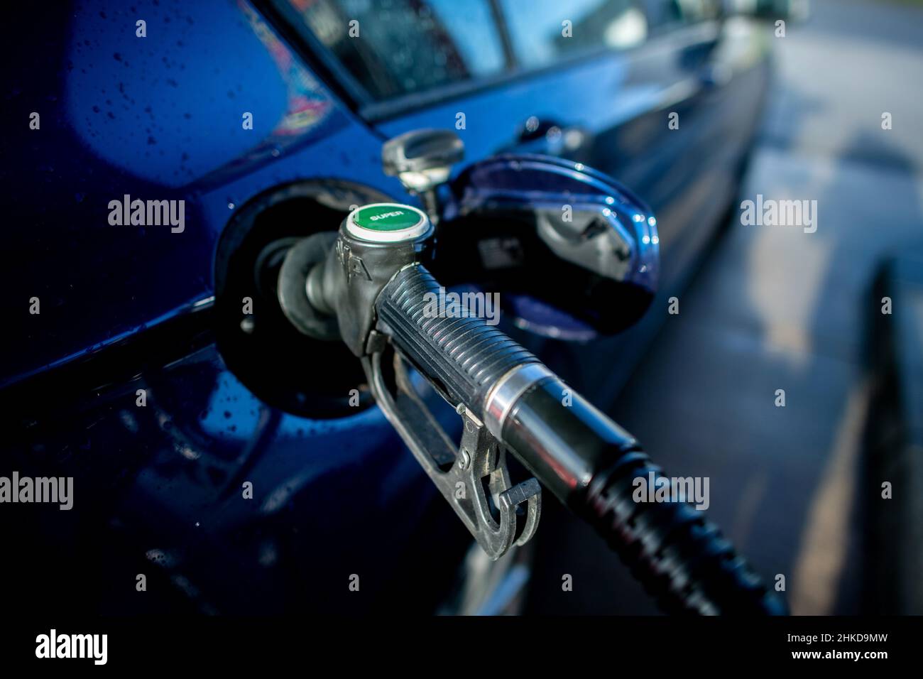 Sandkrug, Germany. 02nd Feb, 2022. A pump nozzle labeled 'Super' is stuck in the tank opening of a vehicle at a gas station. Credit: Hauke-Christian Dittrich/dpa/Alamy Live News Stock Photo