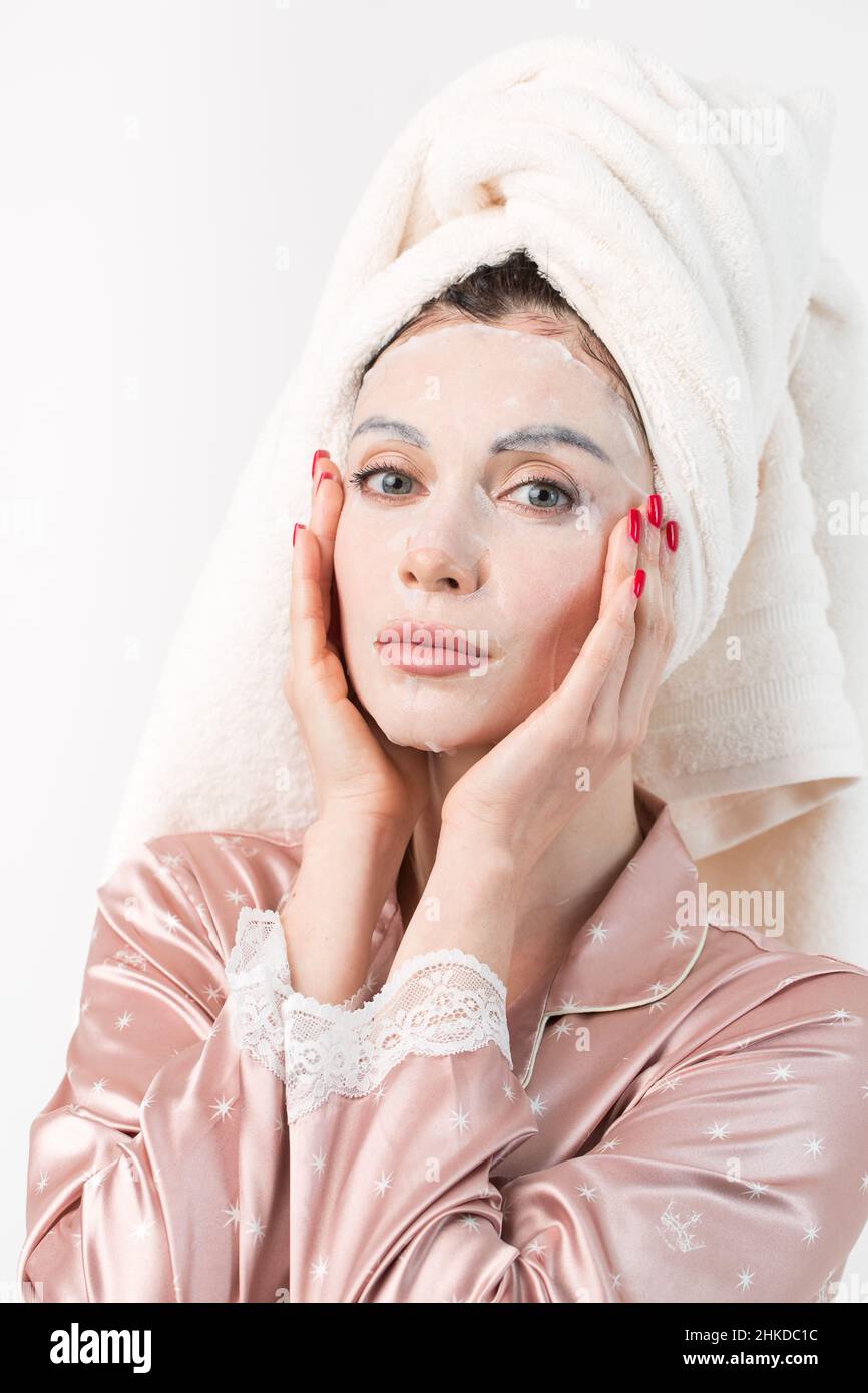 Face care and beauty treatments. Woman with a sheet moisturizing mask