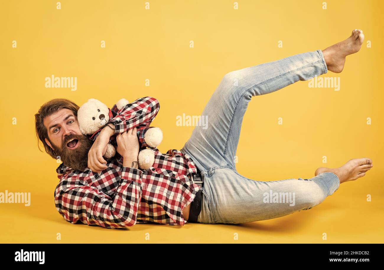 being playful. male feel playful with bear. brutal mature hipster man play with toy. happy birthday. being in good mood. happy valentines day Stock Photo