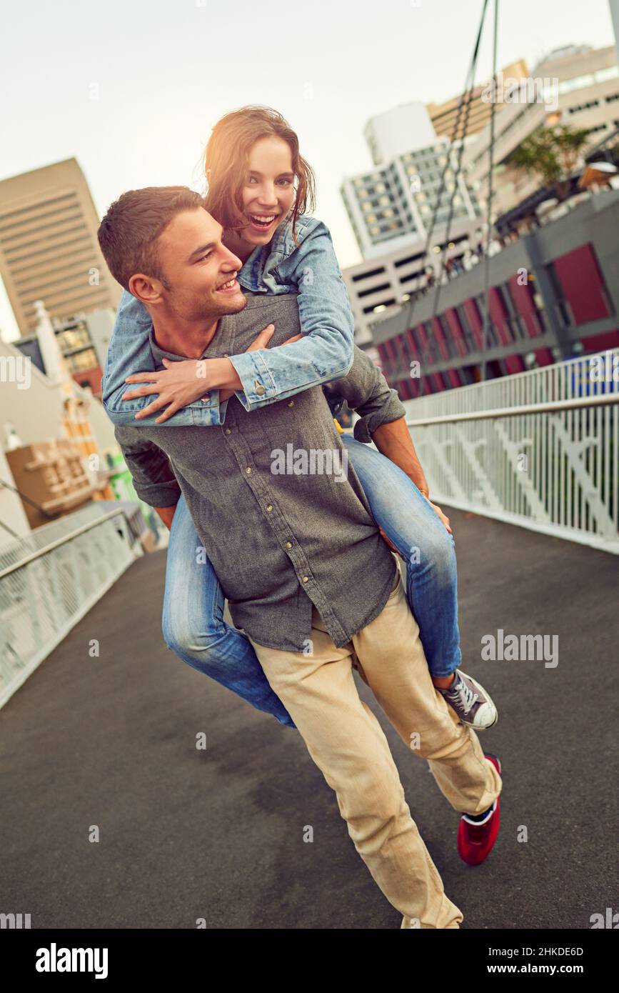 Hitching a ride through the city with my guy Stock Photo - Alamy