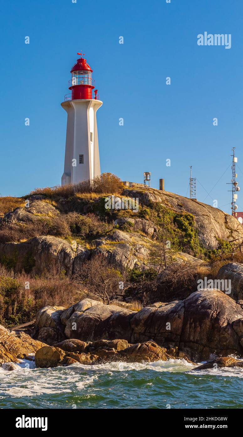Beautiful Lighthouse at rocky hill during sunset. Point Atkinson, West Vancouver BC, Canada-November 11,2020. Nobody, copyspace for text, travel photo Stock Photo