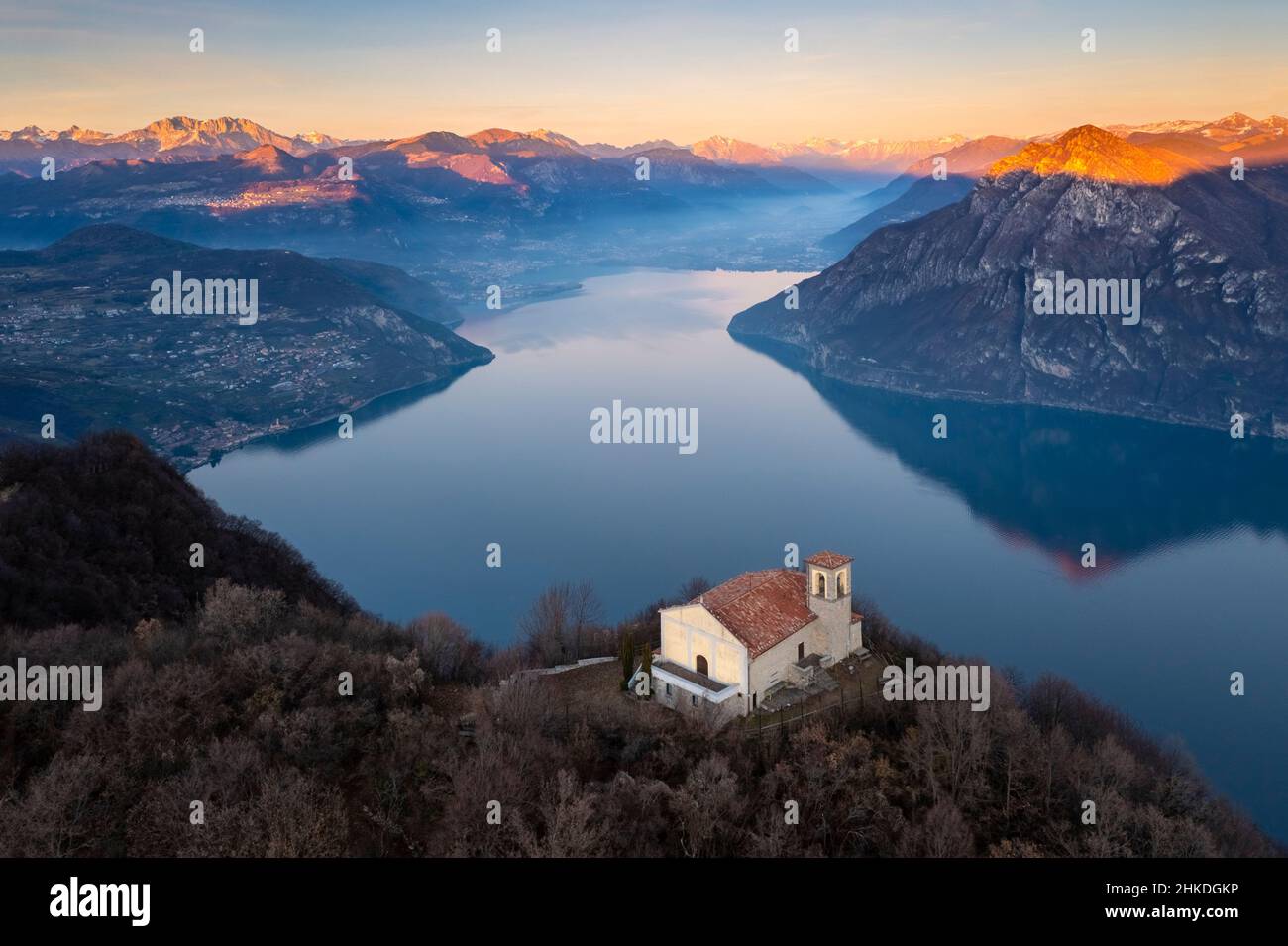 Aerial view of the Santuario della Santissima on Lake Iseo at sunset. Parzanica, Iseo Lake, Bergamo district, Lombardy, Italy. Stock Photo