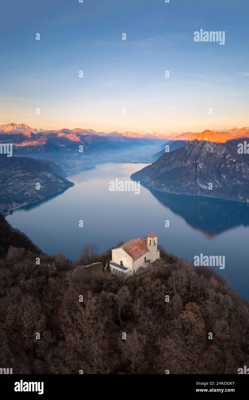 Aerial view of the Santuario della Santissima on Lake Iseo at sunset. Parzanica, Iseo Lake, Bergamo district, Lombardy, Italy. Stock Photo