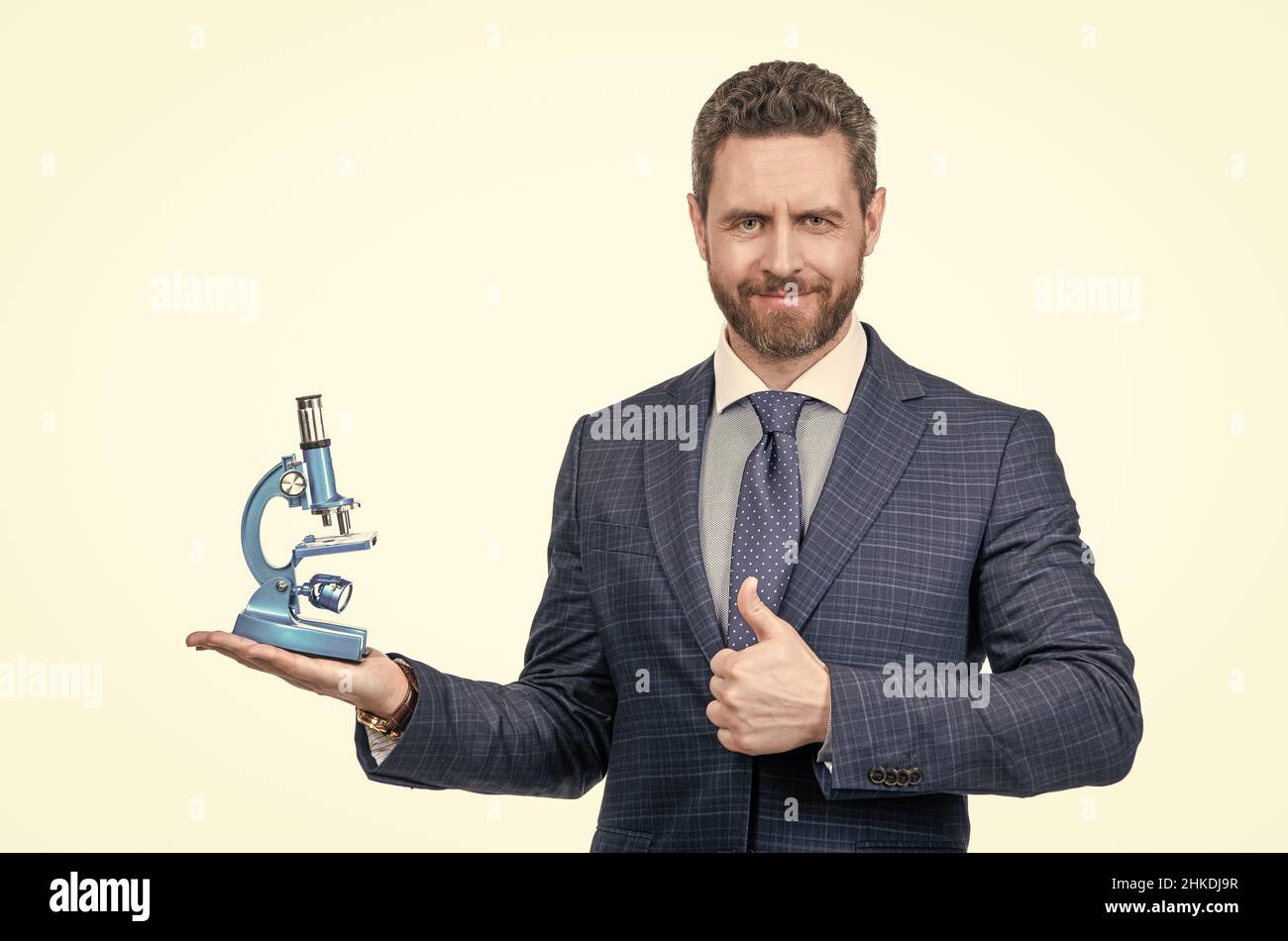 man in suit presenting modern microscope isolated on white show thumb ...
