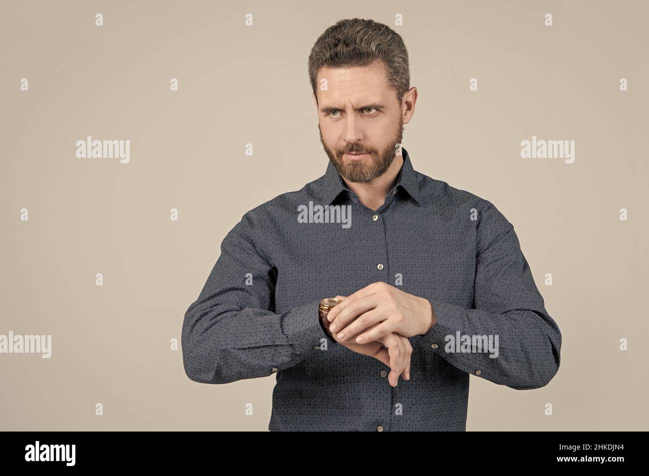 Checking his watch. Bearded man look at wristwatch. Time checking. Deadline date. Being punctual Stock Photo