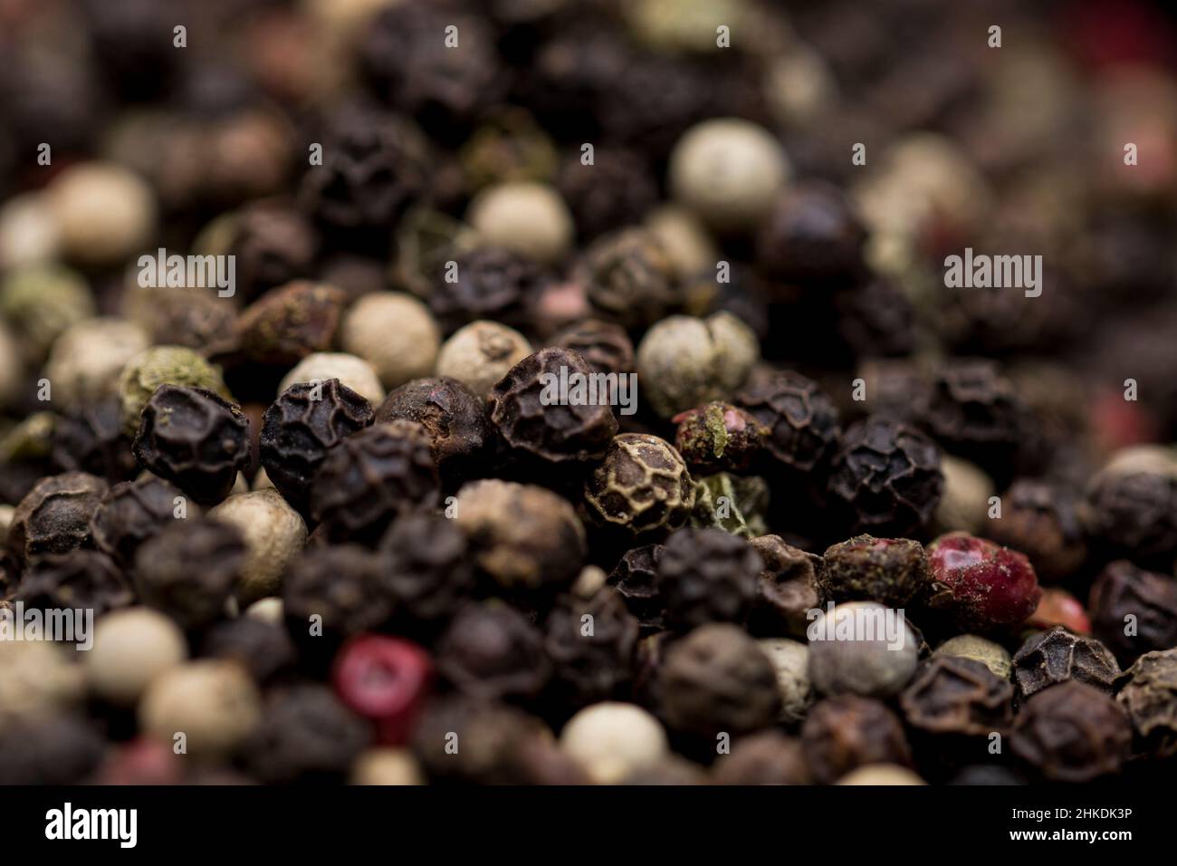 Peppercorn close up black pepper. Macro view of peppercorn seeds. Stock Photo