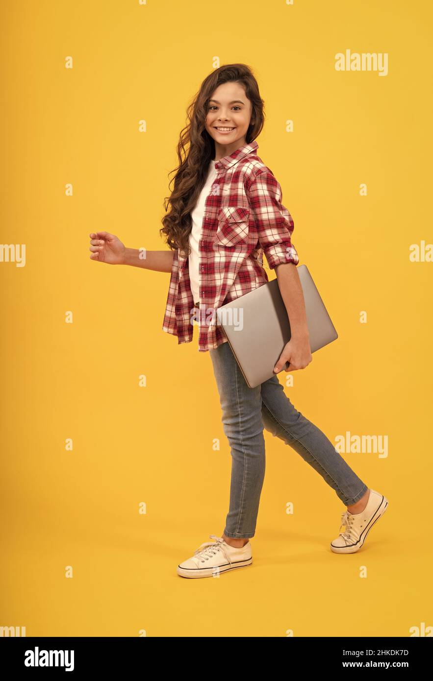 A next-level school. Happy girl child carry laptop. E-learning course. Online course Stock Photo