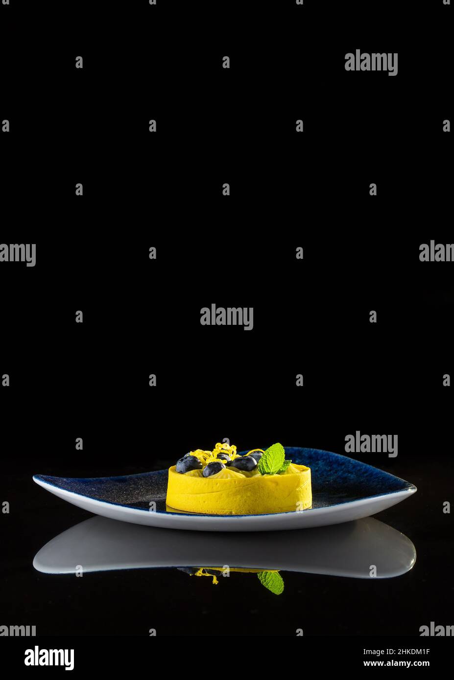 Yellow light dessert on a black background with reflection Stock Photo