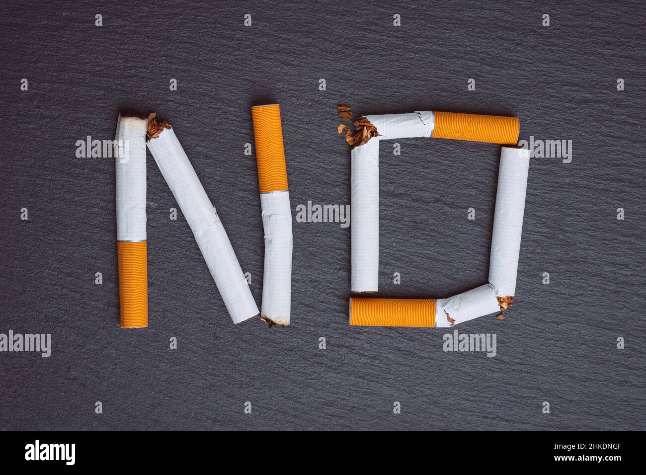 No smoking word made from broken cigarettes on a black background Stock  Photo