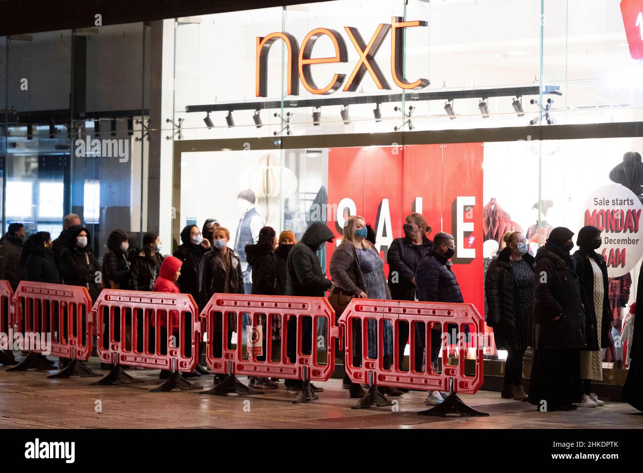 People queue outside a Next store on Queen Street in Cardiff, Wales, United Kingdom for the Boxing Day sales. Stock Photo