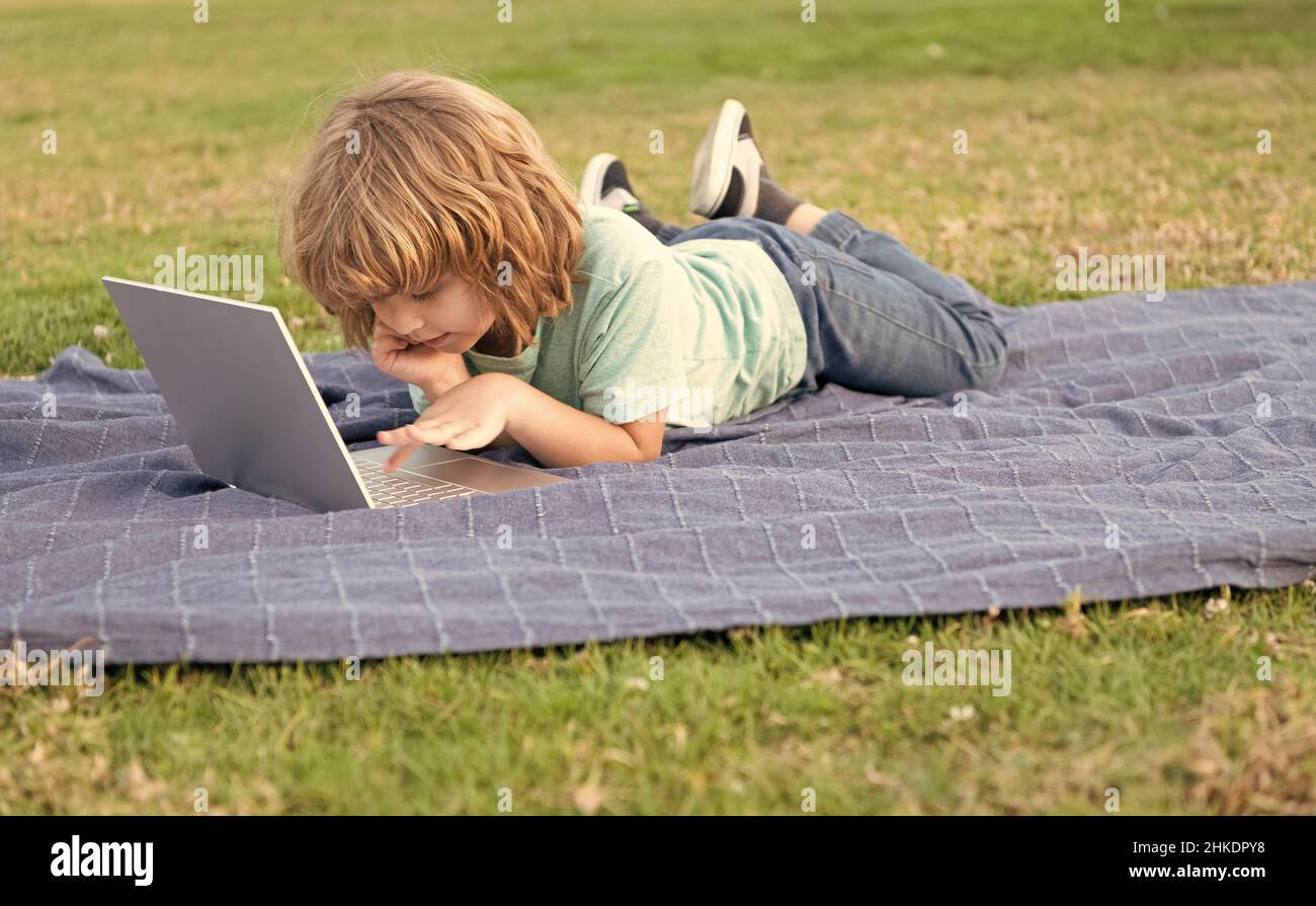 little kid on video lesson. teen boy use laptop. online education. back ...
