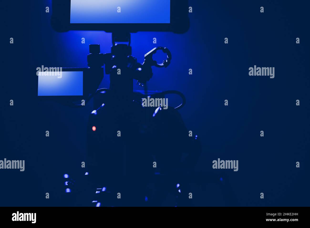 Modern Professional Digital Motion Picture Camera in a Blue Stage Light